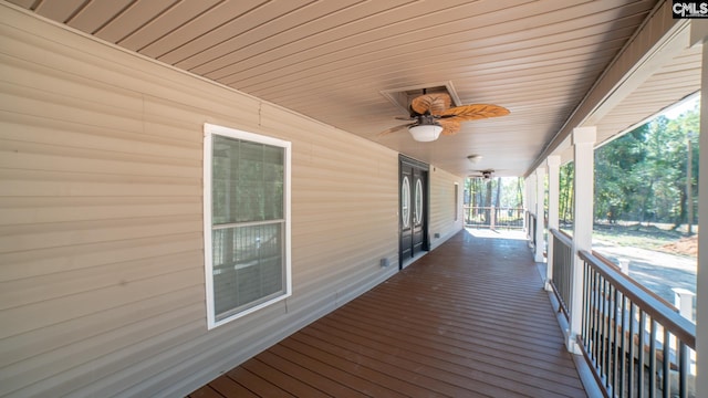 wooden deck featuring ceiling fan