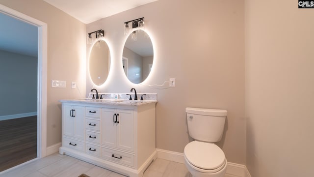 bathroom featuring vanity and toilet