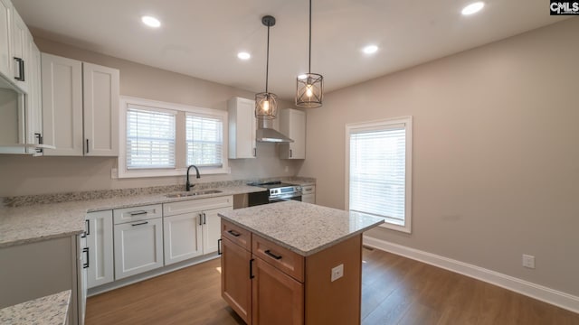 kitchen featuring white cabinetry, a wealth of natural light, and sink