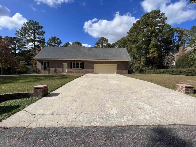 2001 Riding Ridge Rd, Columbia, SC 29223 - view of front of house featuring an attached garage, a front yard, concrete driveway, and brick siding