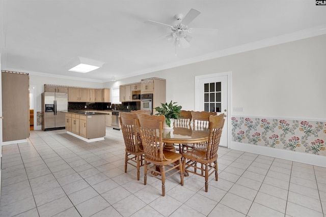 dining room with ornamental molding, sink, light tile patterned flooring, and ceiling fan