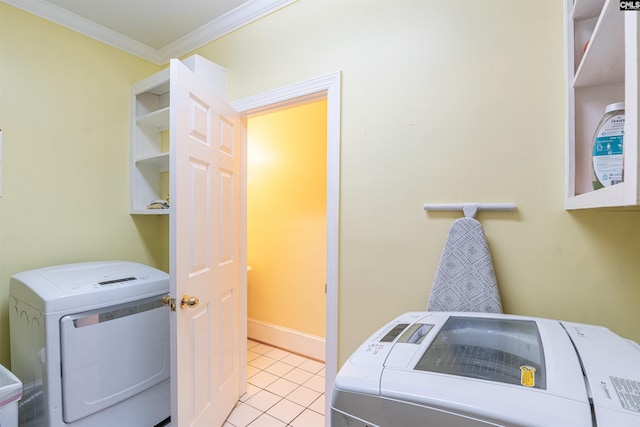 clothes washing area featuring ornamental molding, separate washer and dryer, and light tile patterned floors