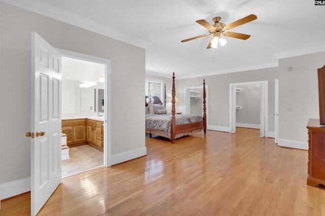 bedroom with crown molding, ceiling fan, light hardwood / wood-style floors, and ensuite bath