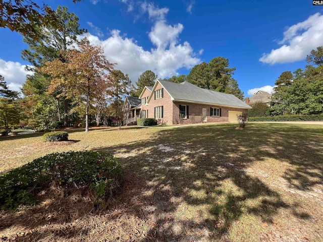 view of side of property with a lawn