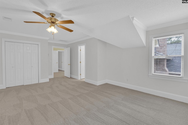 bonus room with light carpet, a textured ceiling, and ceiling fan