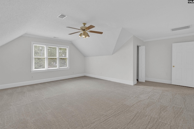 bonus room with ceiling fan, vaulted ceiling, and light colored carpet