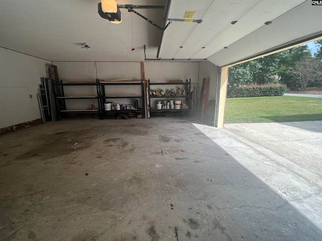 garage featuring a garage door opener and a lawn