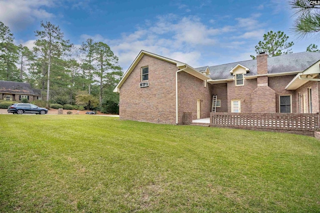 view of side of property with a lawn