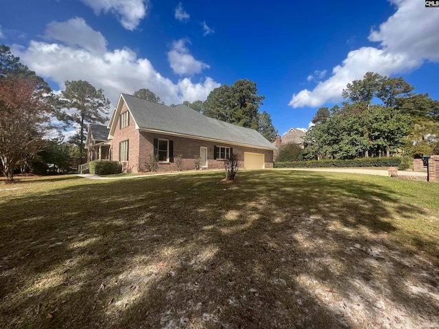 view of side of home with a yard and a garage