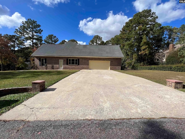 single story home featuring a garage and a front lawn