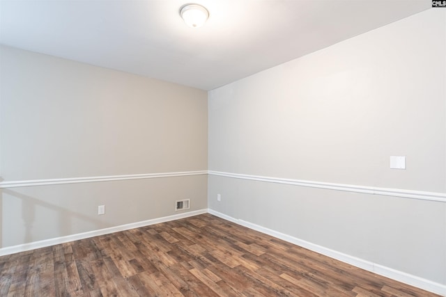 empty room with dark hardwood / wood-style flooring