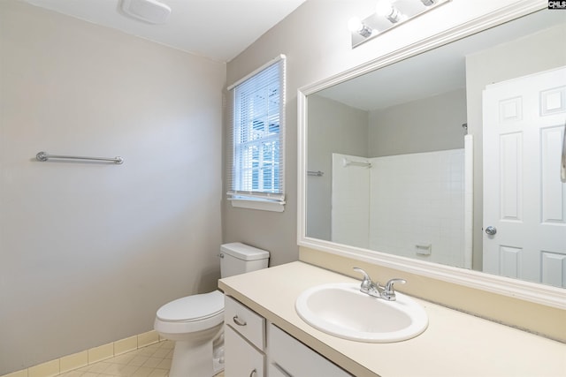 bathroom with toilet, walk in shower, vanity, and tile patterned floors