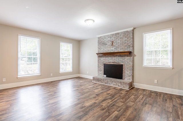 unfurnished living room featuring dark hardwood / wood-style floors and a fireplace