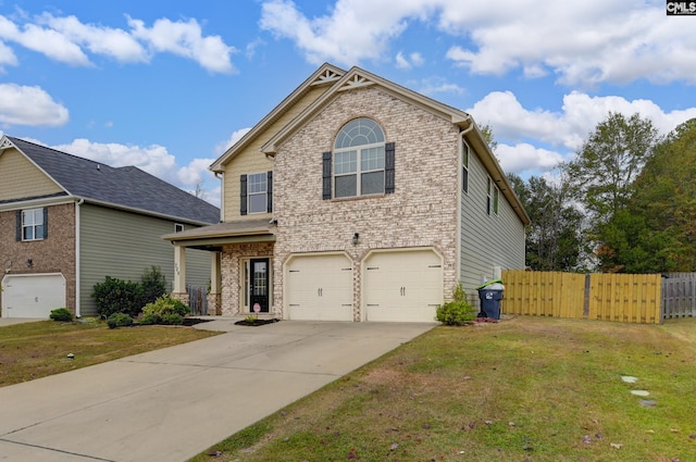 view of property featuring a front yard and a garage