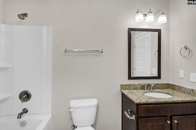 full bathroom featuring toilet, vanity, and  shower combination