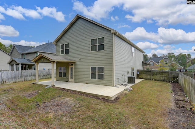 back of house with a patio, central AC unit, and a lawn