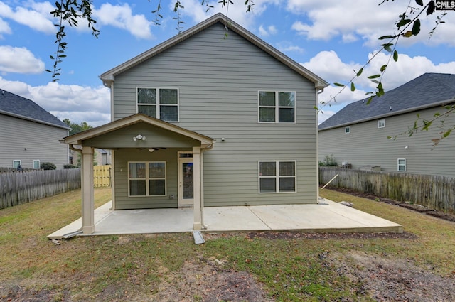 back of house featuring a patio area, a lawn, and ceiling fan