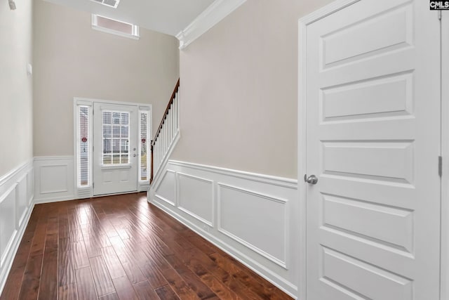 foyer with crown molding and dark hardwood / wood-style floors