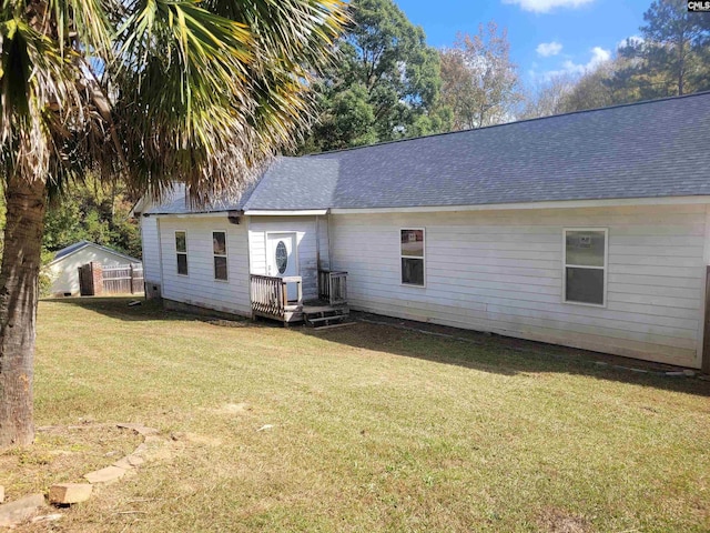 rear view of property featuring a yard