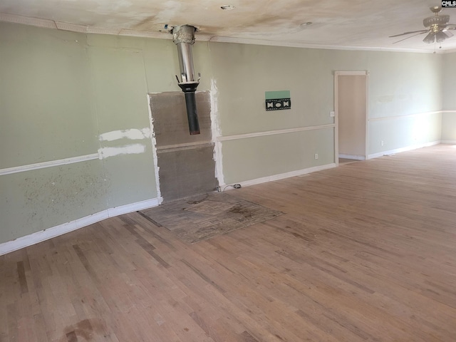 interior space with crown molding, wood-type flooring, and ceiling fan