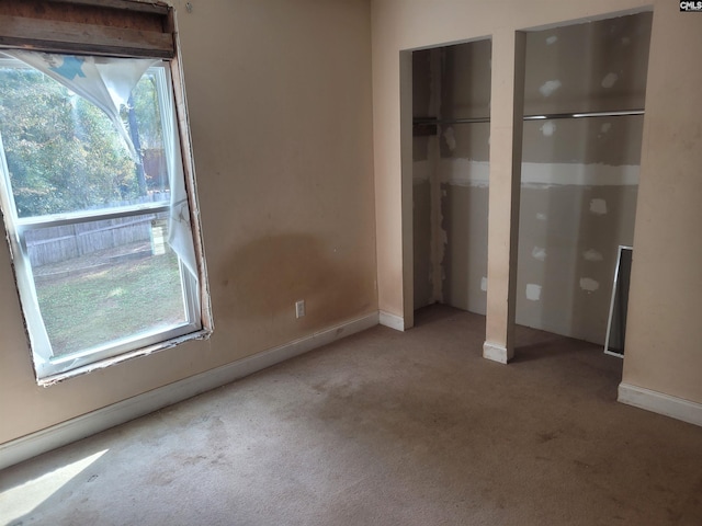 unfurnished bedroom featuring light carpet