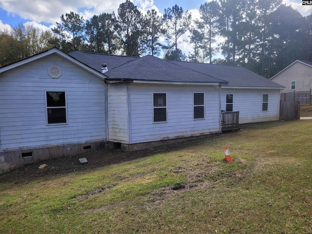 back of property featuring a lawn