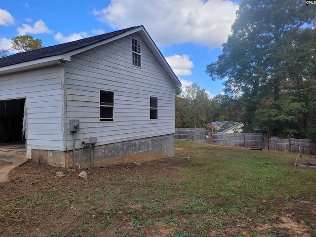 view of side of home with a lawn