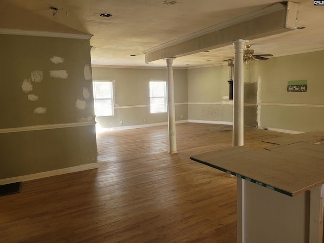 basement with ornamental molding, hardwood / wood-style flooring, and ceiling fan