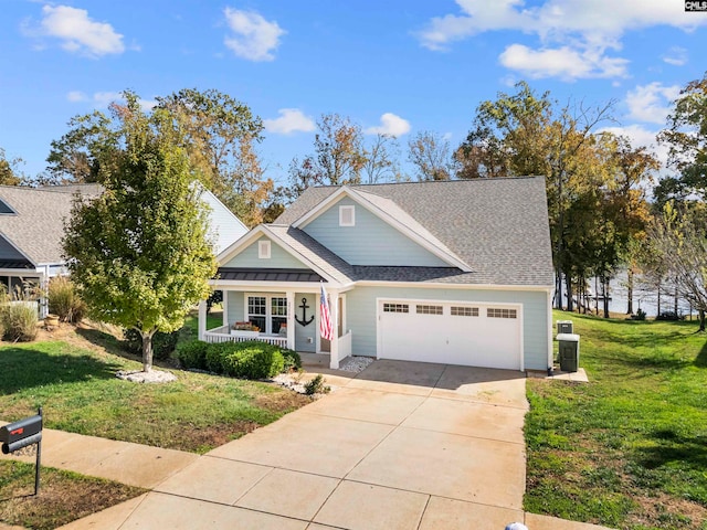 view of front of property featuring a front yard, a porch, and a garage