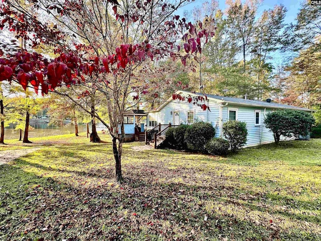 view of property exterior featuring a lawn