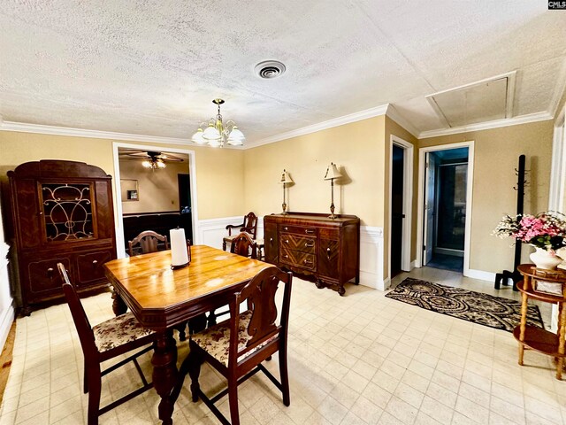 dining area featuring ornamental molding, a textured ceiling, and ceiling fan with notable chandelier