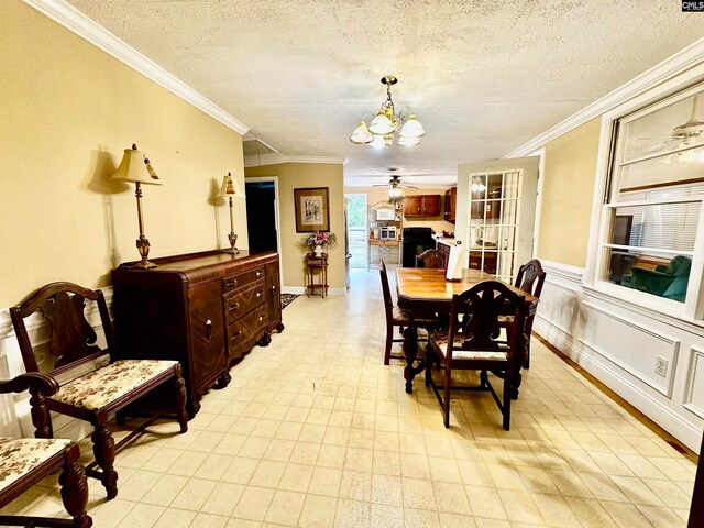 dining room with crown molding, a textured ceiling, and ceiling fan with notable chandelier