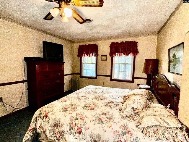 bedroom featuring ornamental molding, a textured ceiling, and ceiling fan