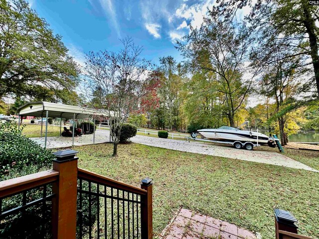 view of yard with a water view and a carport