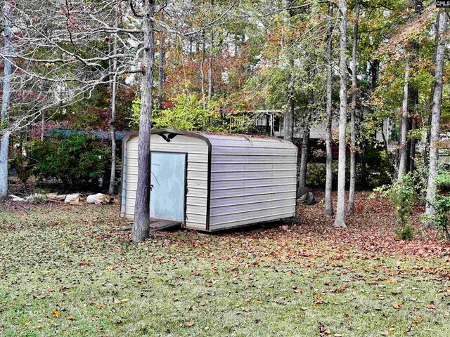 view of outbuilding featuring a lawn