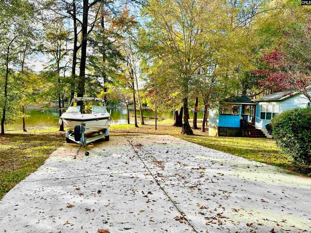 view of home's community featuring a lawn and a water view