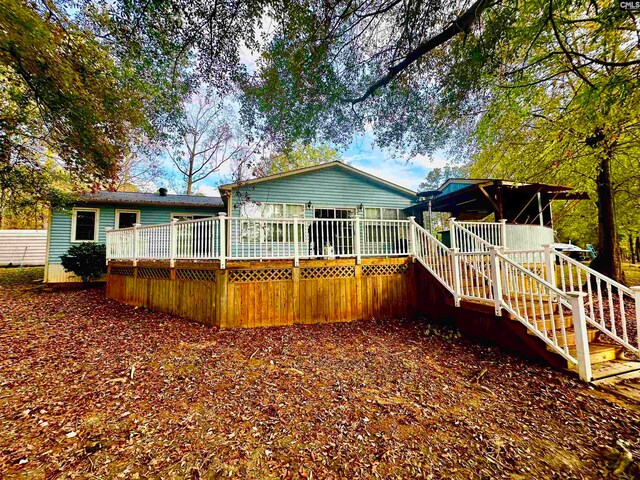 rear view of property with a wooden deck