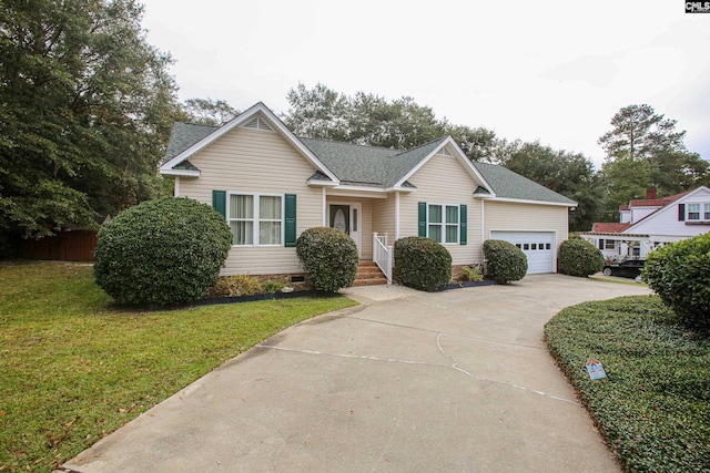 view of front of house featuring a front lawn and a garage