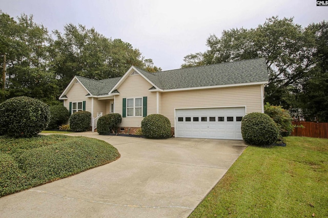 view of front of house with a front lawn and a garage