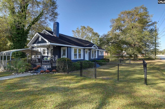 view of front of house with a front lawn, covered porch, and a carport