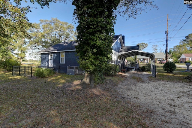 view of side of property with a carport and cooling unit