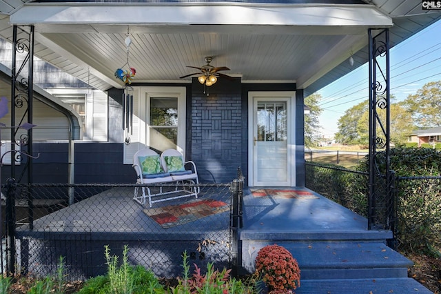 property entrance featuring ceiling fan and a porch