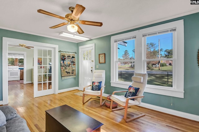 sitting room featuring ceiling fan, ornamental molding, and hardwood / wood-style floors