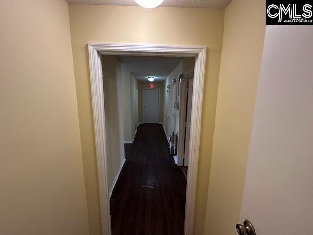 corridor with dark hardwood / wood-style floors