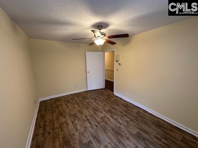 spare room featuring a textured ceiling, ceiling fan, and dark hardwood / wood-style flooring