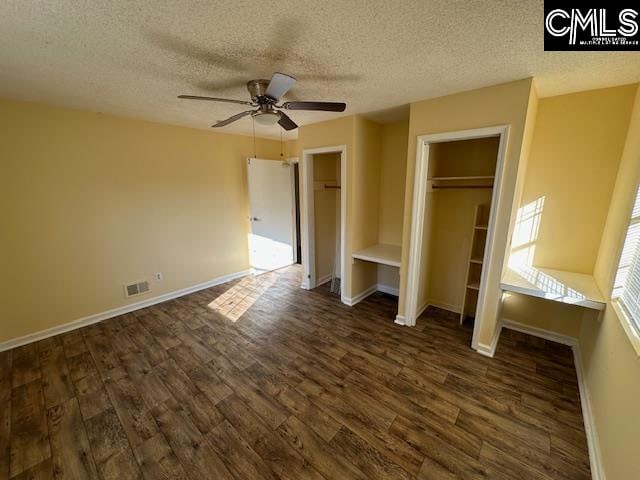 unfurnished bedroom featuring a textured ceiling, ceiling fan, and dark hardwood / wood-style flooring