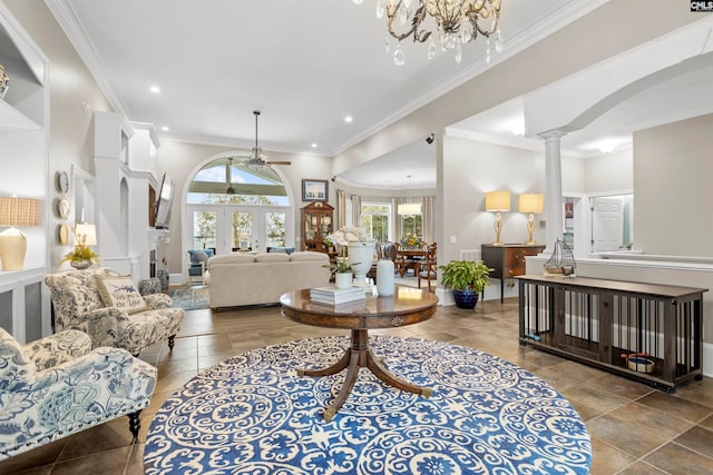 living room featuring decorative columns, ornamental molding, and tile patterned flooring