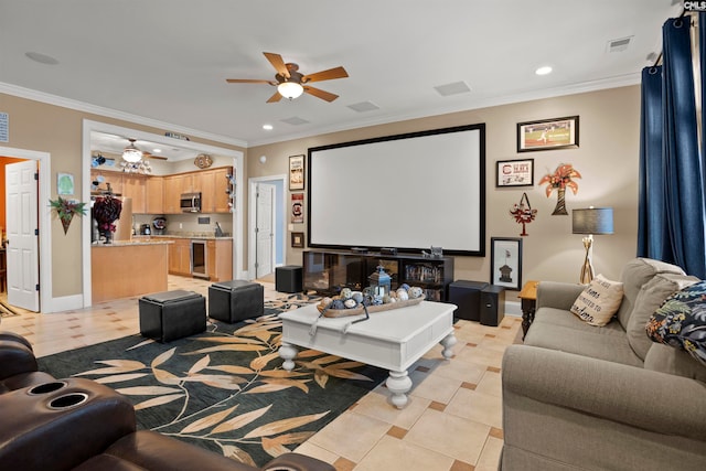 home theater room with ceiling fan, wine cooler, ornamental molding, and light tile patterned floors