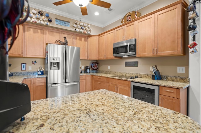 kitchen featuring light stone counters, stainless steel appliances, ornamental molding, and beverage cooler