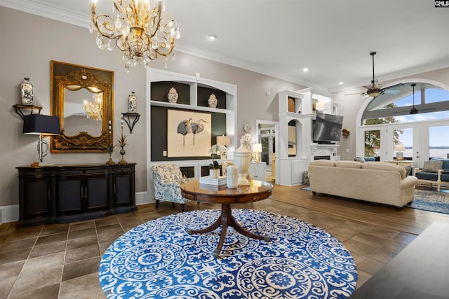 living room featuring ornamental molding, french doors, and ceiling fan with notable chandelier